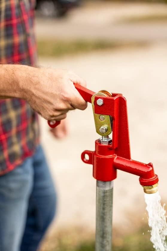 Close-up of a red Merrill frost-proof yard hydrant handle with water flowing